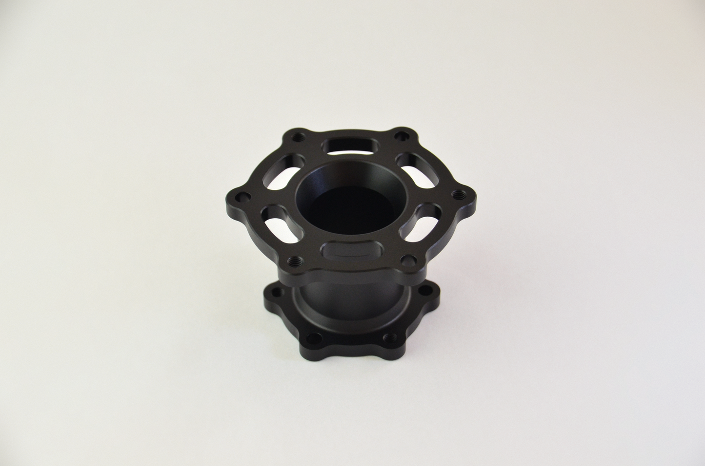 Precision CNC-machined anodized aluminium spacer for sim racing wheels and quick release mounts.