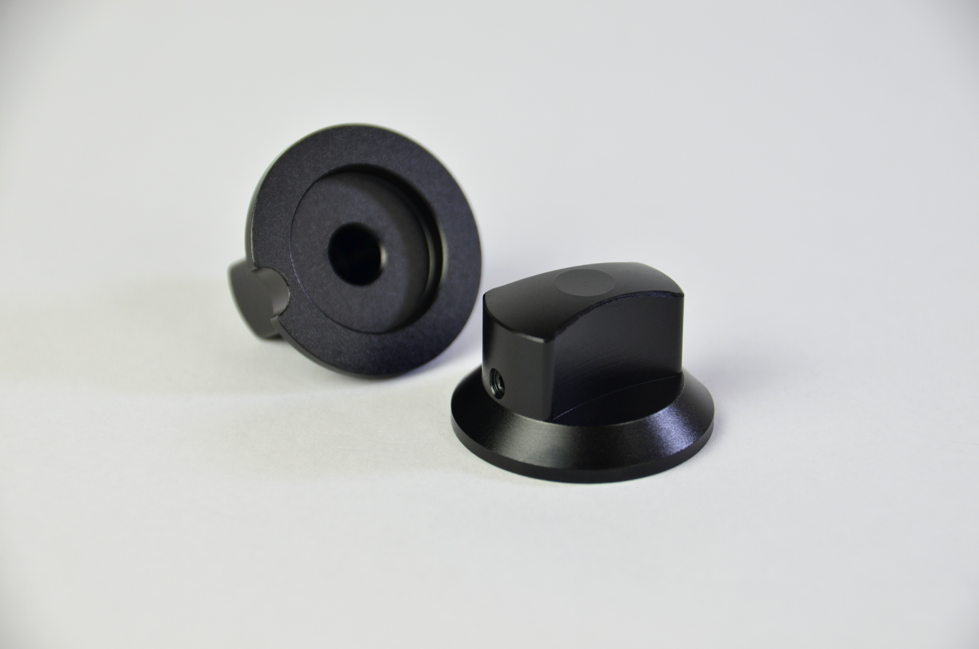 Two black anodized aluminium rotary knobs for sim racing DIY project.