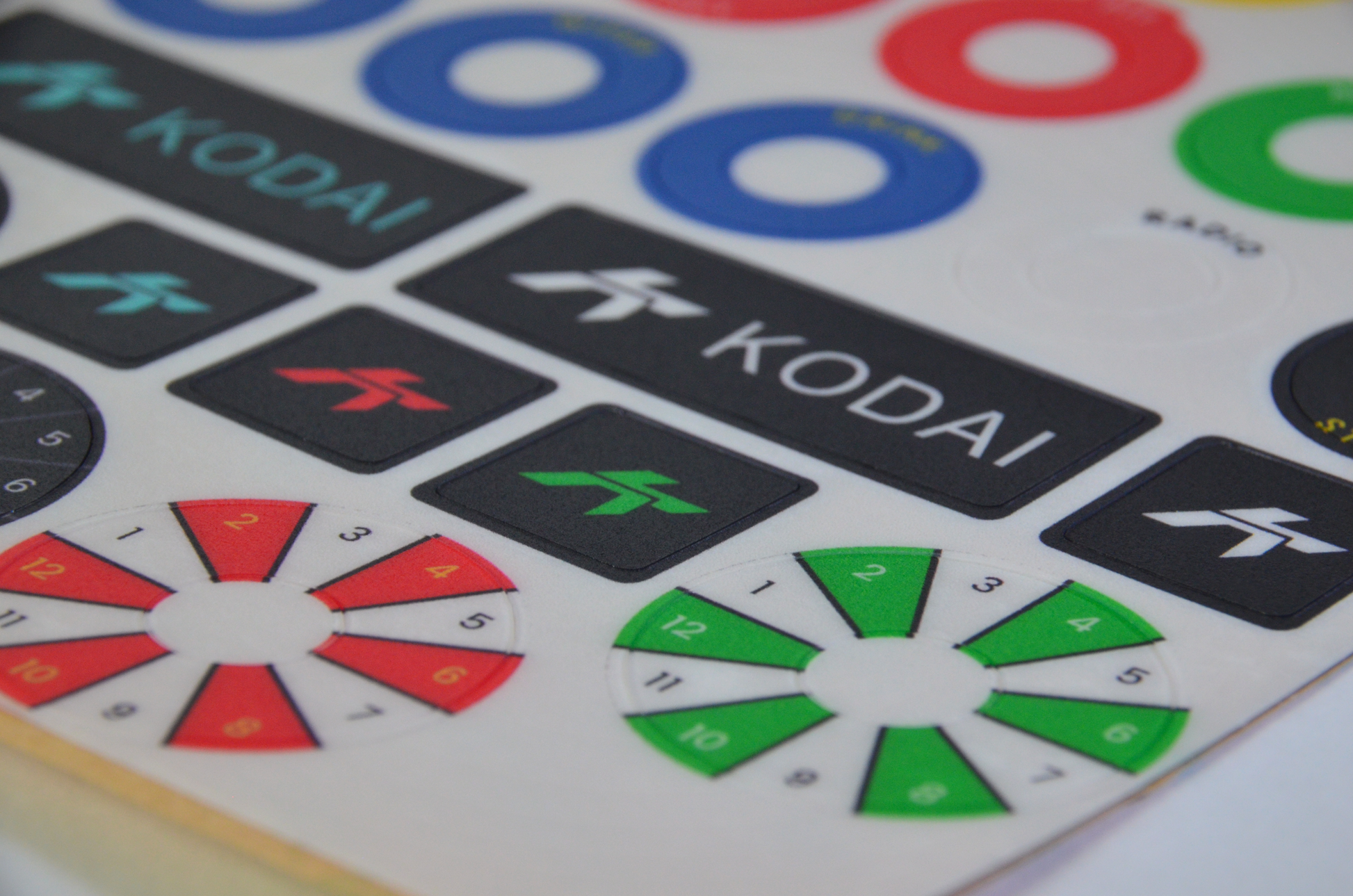 GT-R polycarbonate decal sheet for DIY sim racing steering wheel build button labels. Close up side view.