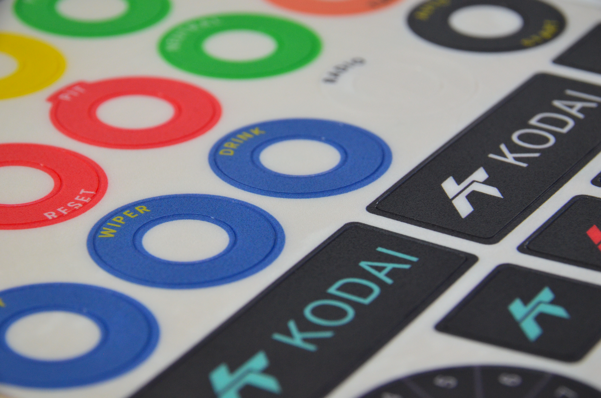 GT-R polycarbonate decal sheet for DIY sim racing steering wheel build button labels. Close up view.