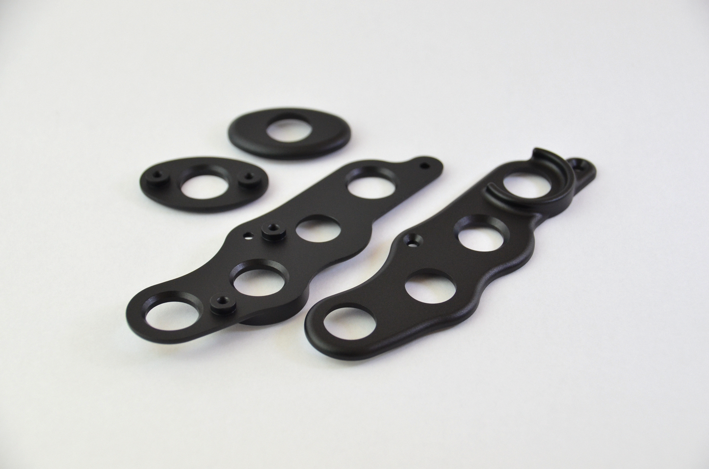 CNC machined aluminium button surrounds with a black anodized finish, designed for the MF1 DIY sim racing wheel.