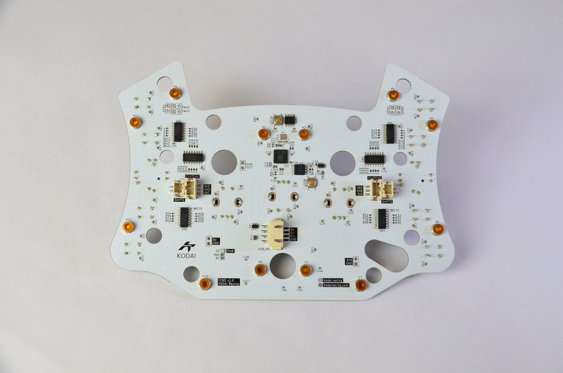 Custom PCB for TCR3 DIY sim racing project with various electronic components and connection ports visible. Rear view.