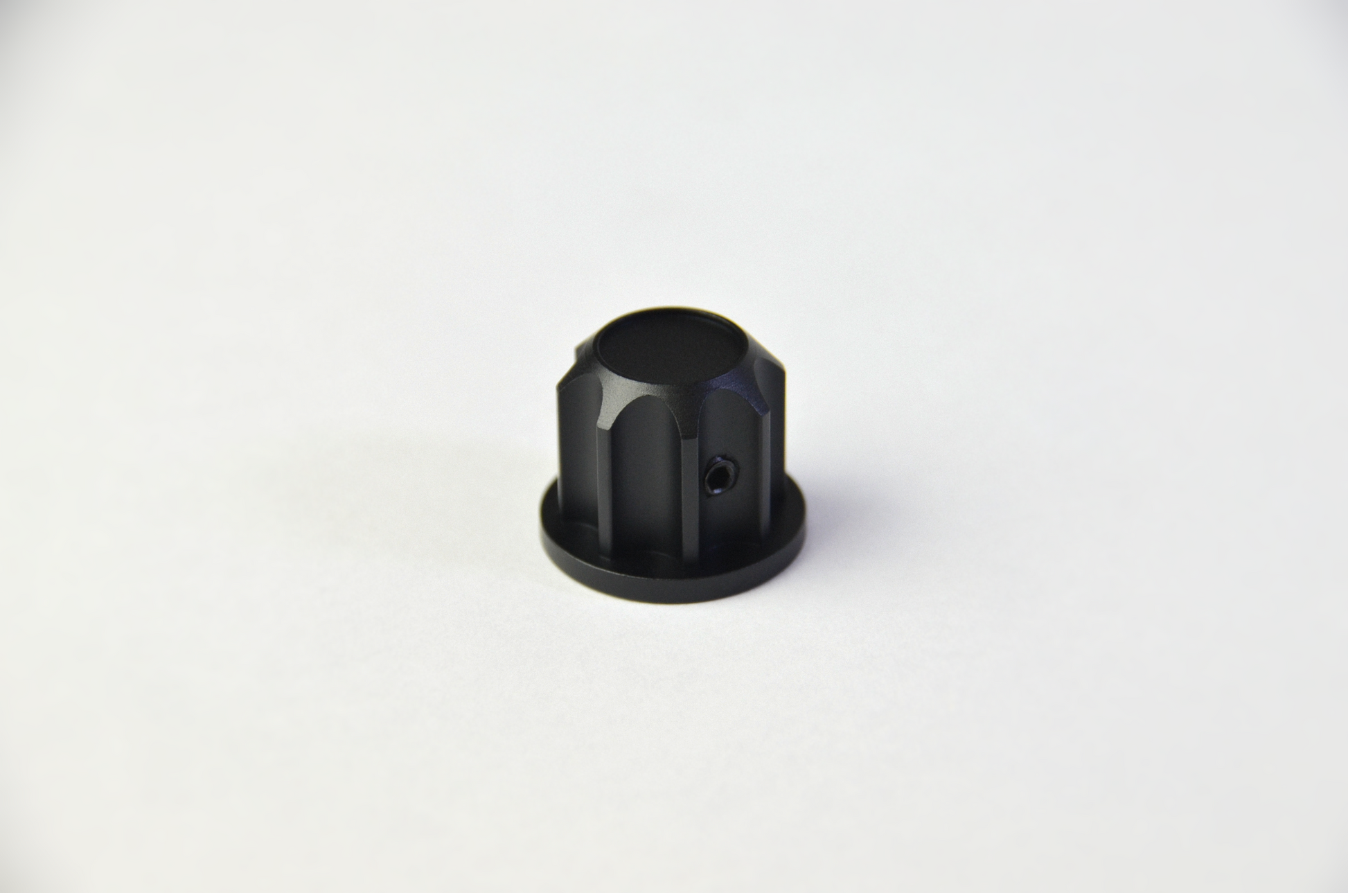 A black anodized aluminium rotary knob designed for use with the TCR3 DIY project. Front view.