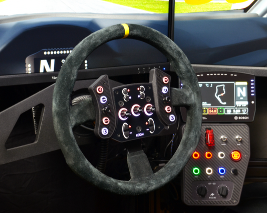 TCR3 DIY button plate mounted on sim racing rig with orange LED lighting, custom sim racing setup. Front side view.