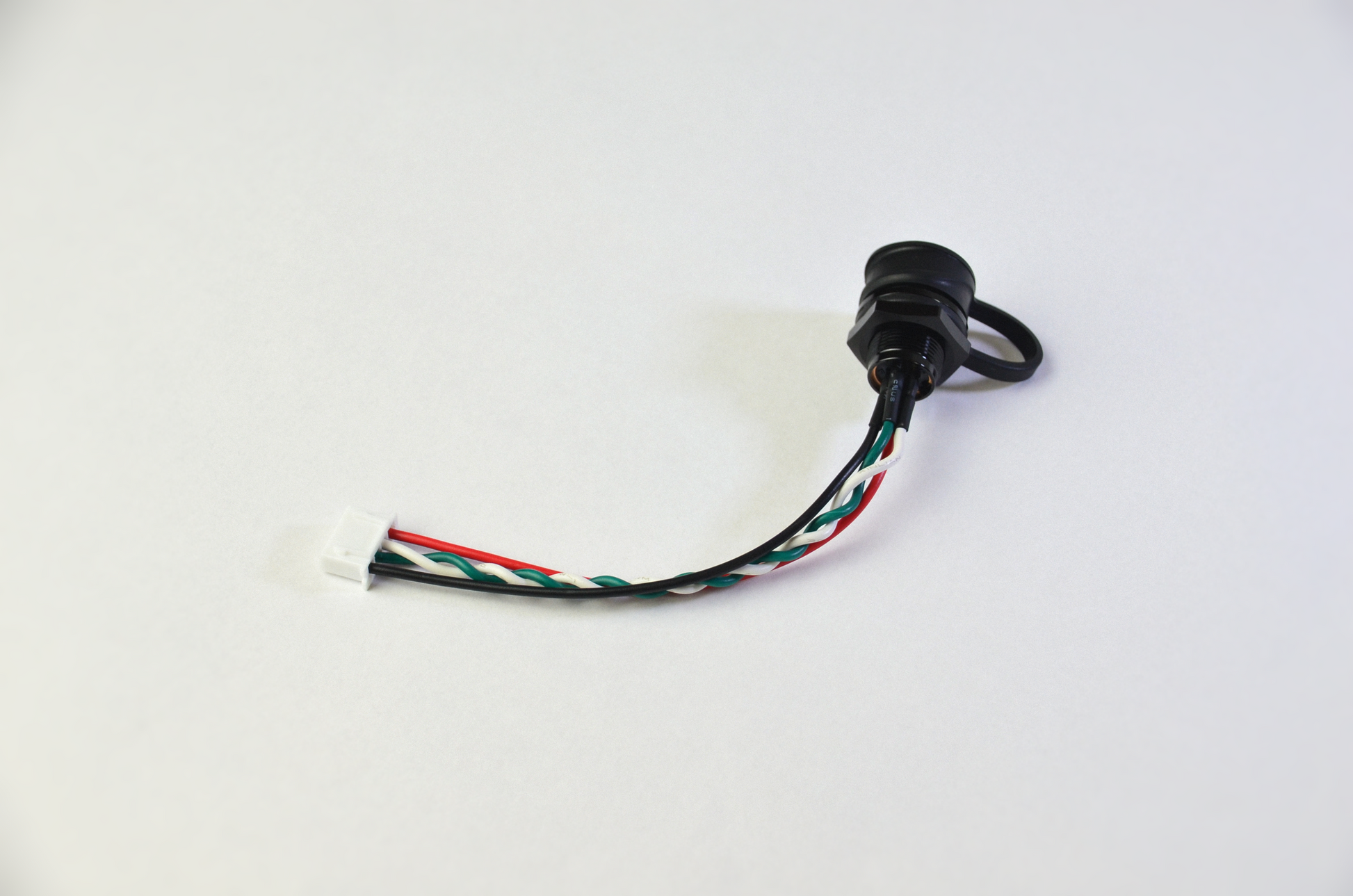 A Weipu to JST connector cable with black, red, white and green wires, a white connector on one end and a black Weipu connector on the other. Rear View.