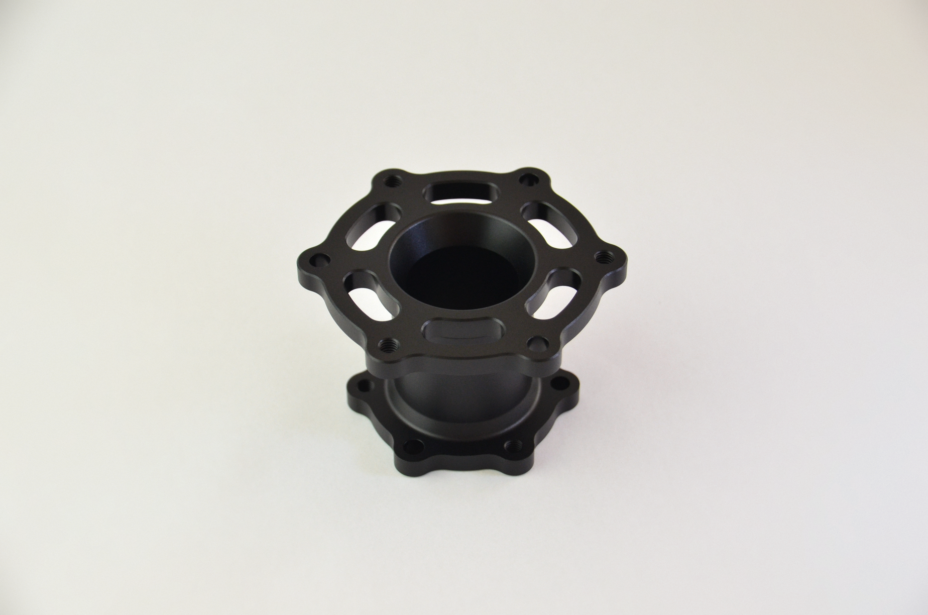 Precision CNC-machined anodized aluminium spacer for sim racing wheels and quick release mounts.
