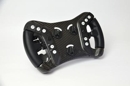 High-end AM2 GT sim racing wheel with rotary encoders, paddles, and RGB buttons. Aluminium and carbon fibre.