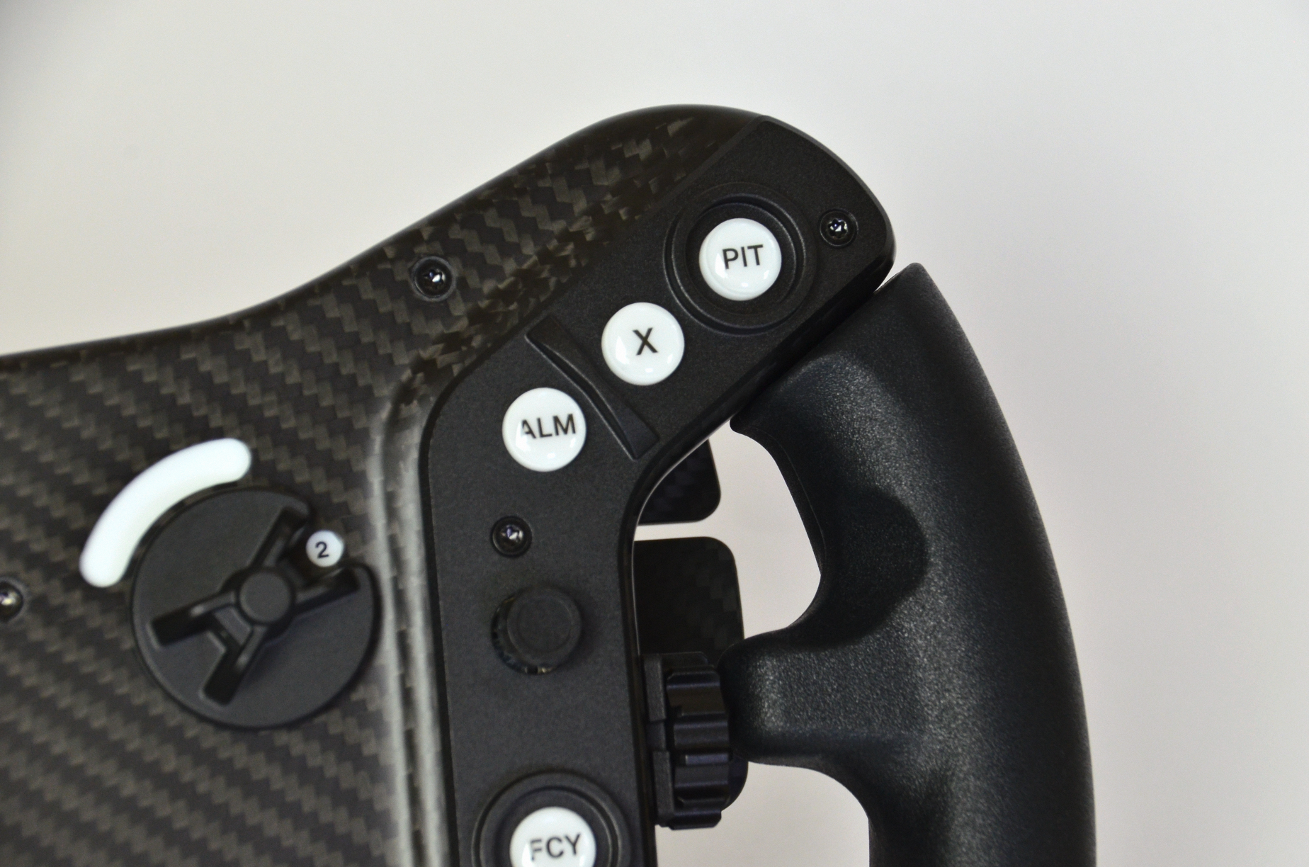 High-end AM2 GT sim racing wheel with rotary encoders, paddles, and RGB buttons. Aluminium and carbon fibre.