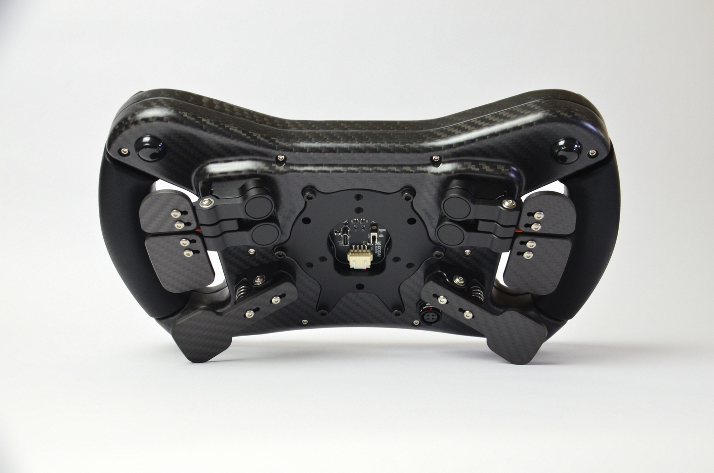 High-end GZ GT sim racing wheel with rotary encoders, paddles, and RGB buttons. Aluminium and carbon fibre.