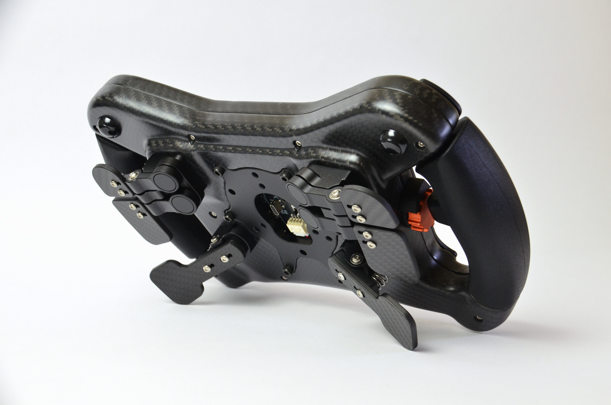 High-end GZ GT sim racing wheel with rotary encoders, paddles, and RGB buttons. Aluminium and carbon fibre.