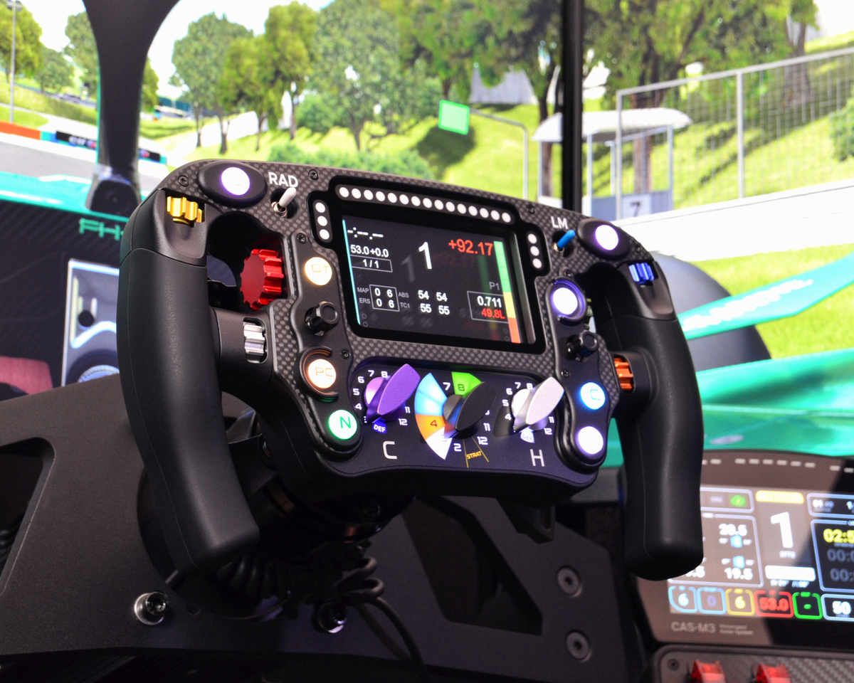 High-end MF1 sim racing wheel with rotary encoders, paddles, and RGB buttons. Aluminium and carbon fibre.