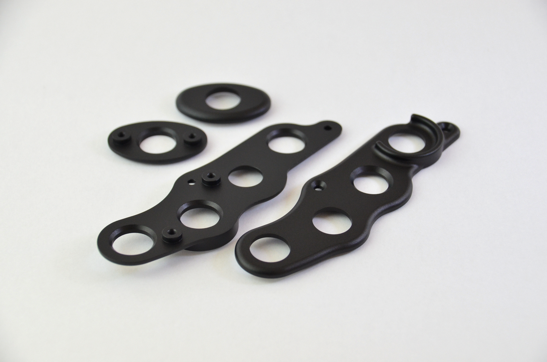 CNC machined aluminium button surrounds with a black anodized finish, designed for the MF1 DIY sim racing wheel.