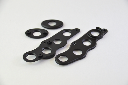 CNC machined aluminium button surrounds with a black anodized finish, designed for the MF1 DIY sim racing wheel.